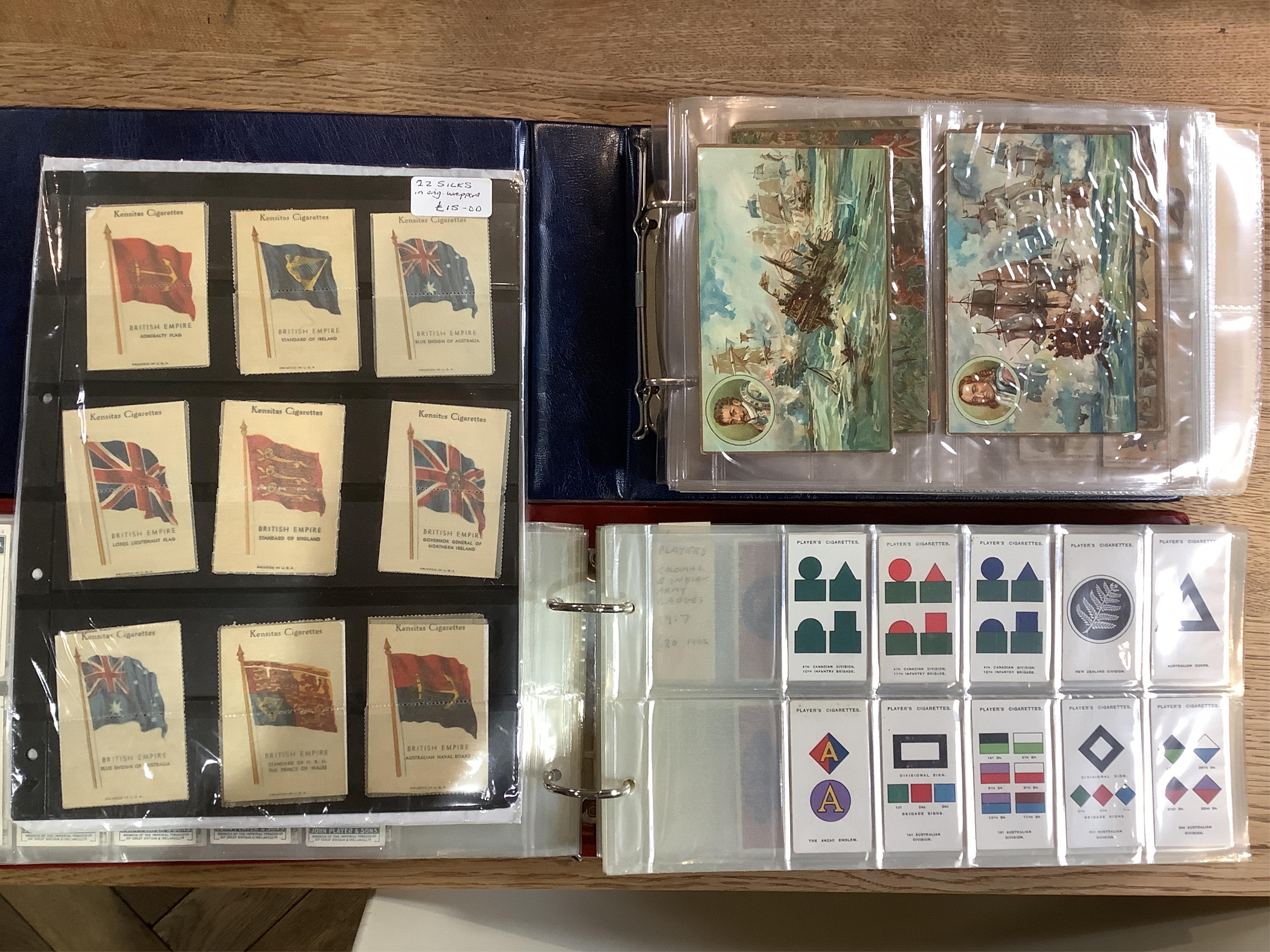 Four albums of assorted cigarette cards; military badges, heroes, soldiers and war, and some loose silks.